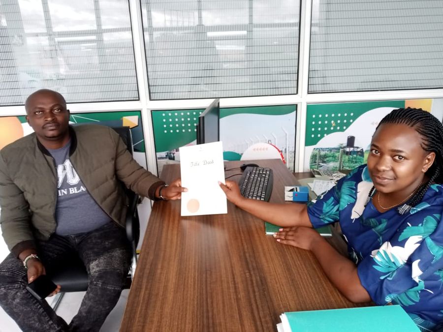Happy client collecting his title deed
